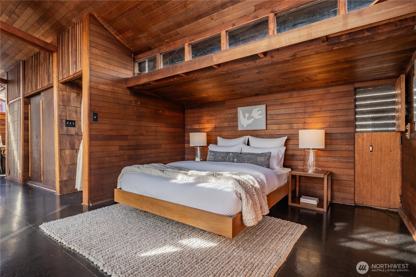 3130 Portage Bay Place East, Unit C Seattle, WA 98102 - Photo 21 of 40 a bed sitting in a room next to a brick wall