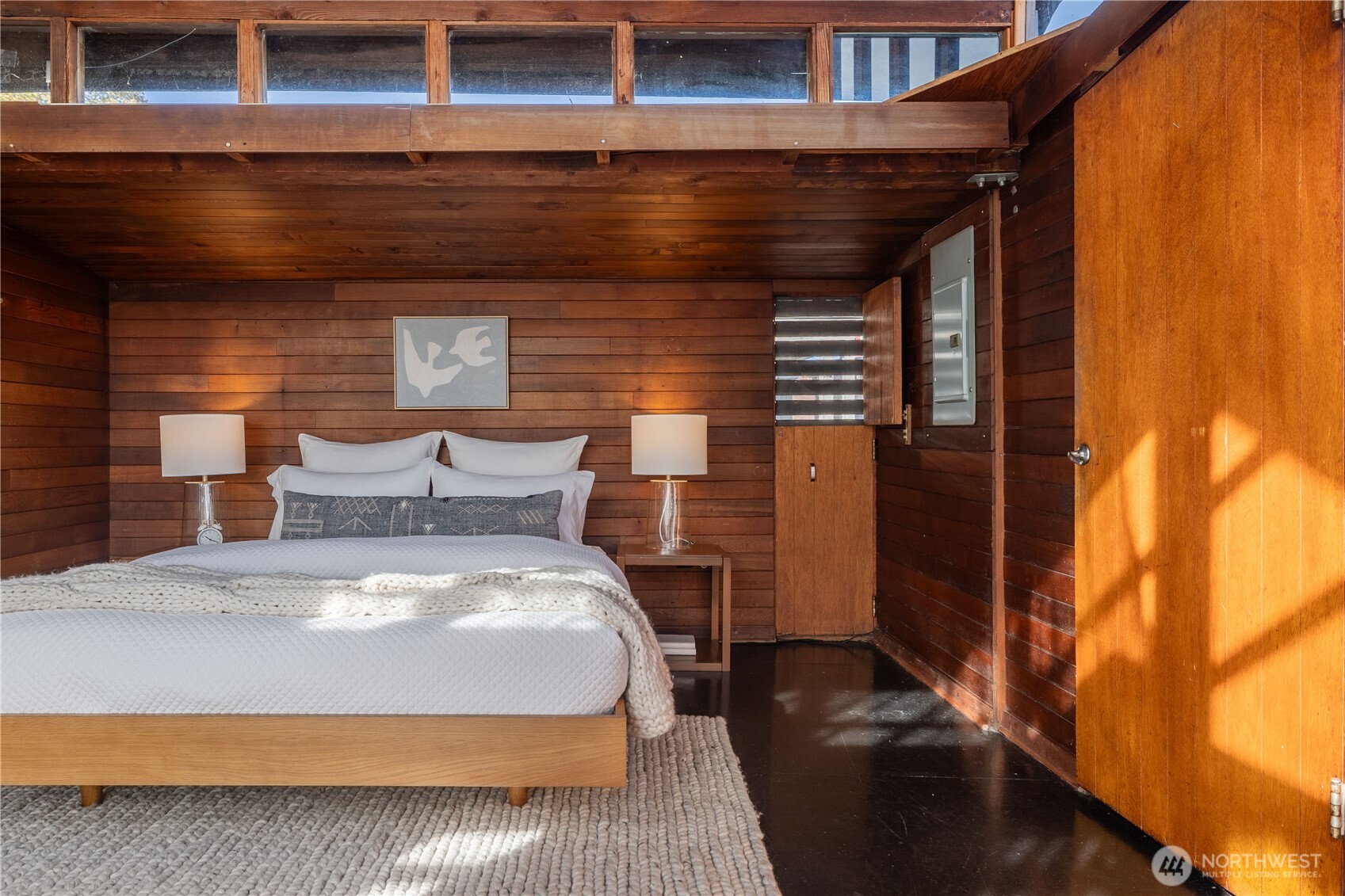 3130 Portage Bay Place East, Unit C Seattle, WA 98102 - Photo 23 of 40 a bed sitting in a room next to a blue wall