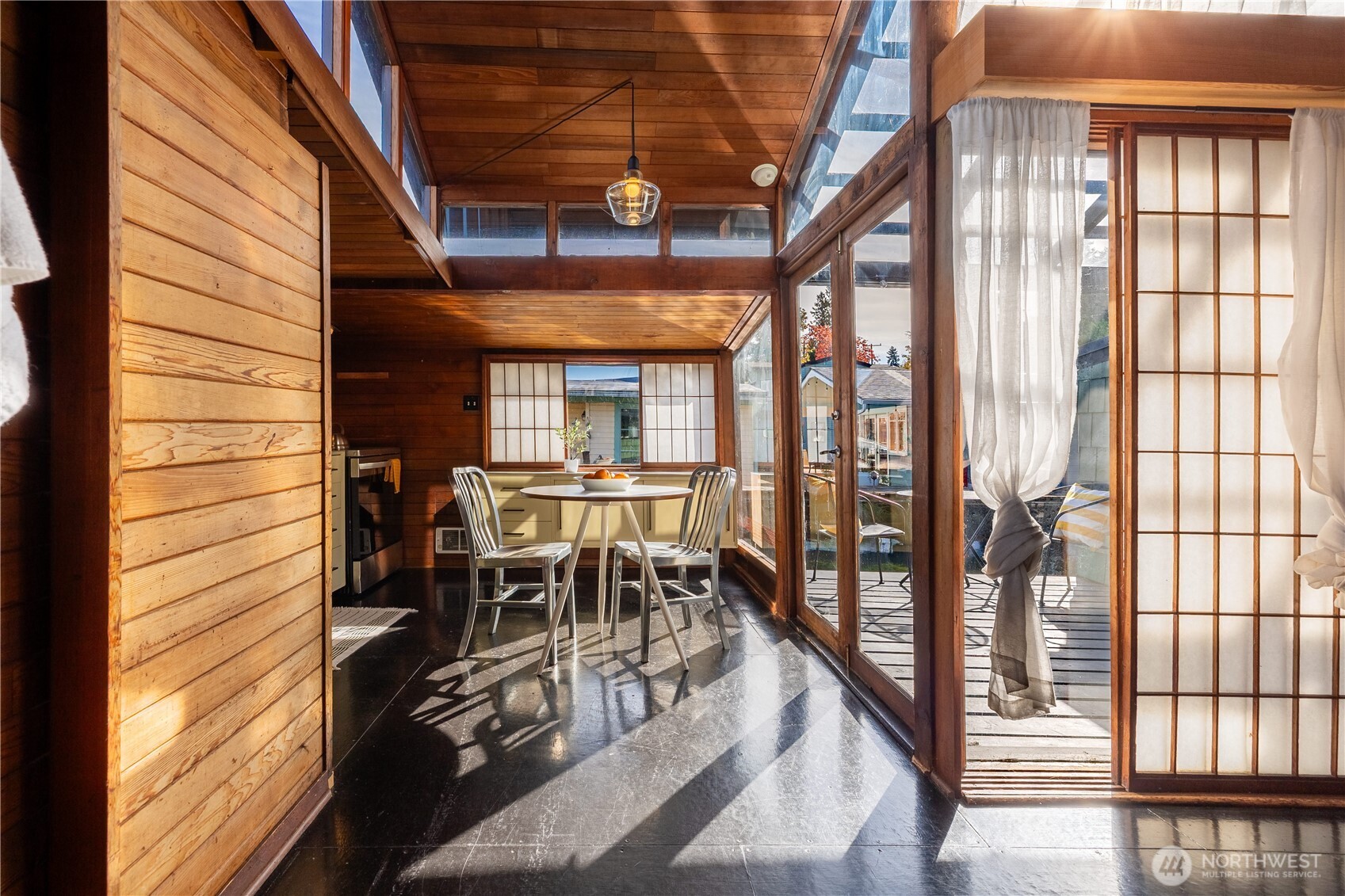 3130 Portage Bay Place East, Unit C Seattle, WA 98102 - Photo 10 of 40 a dining room with furniture water view and a floor to ceiling window