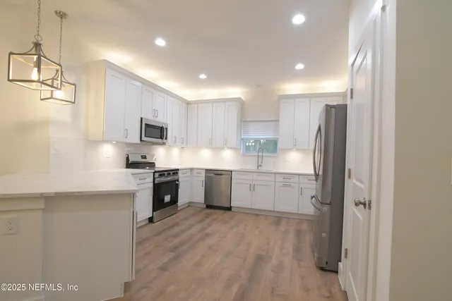 a view of a kitchen and a sink