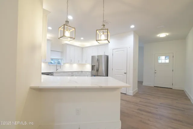 a kitchen with a refrigerator and a sink