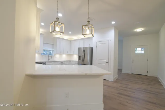 a kitchen with cabinets and stainless steel appliances