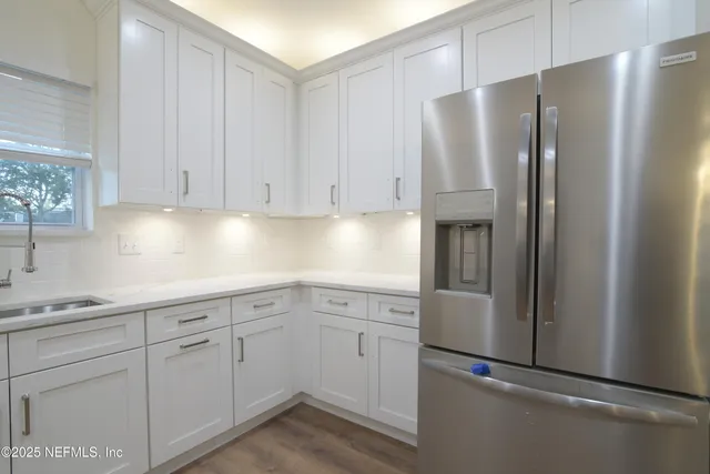 a kitchen with stainless steel appliances granite countertop a sink stove and microwave