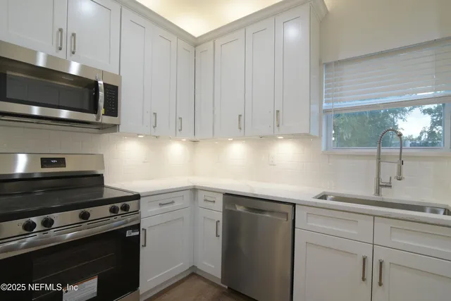 a view of a hallway with chandelier