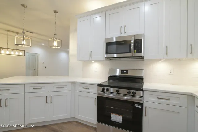 a view of a room with wooden floor and windows
