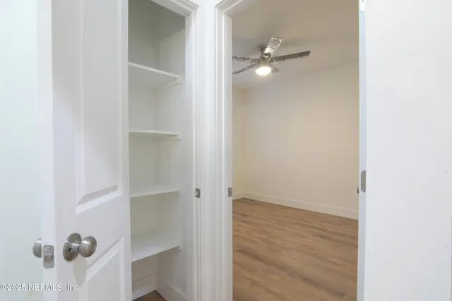 a bathroom with a granite countertop sink a toilet and a mirror