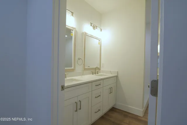 a bathroom with a shower sink and mirror