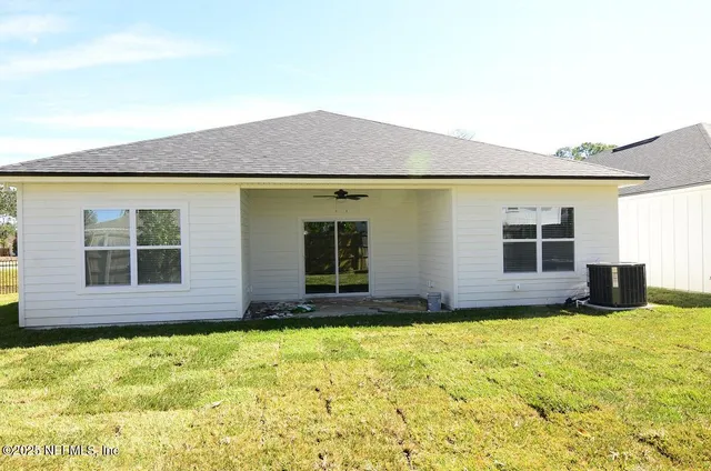 a view of a house with a backyard