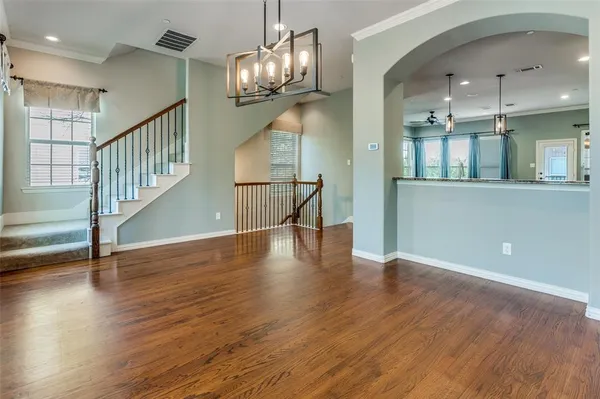 a view of staircase and kitchen with wooden floor