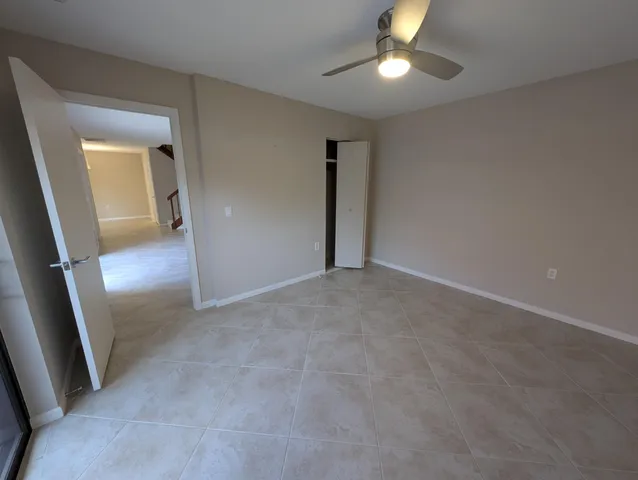 en empty room with stairs and wooden floor