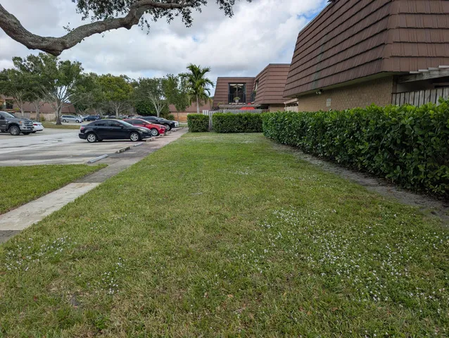 a view of a lake in middle of a yard