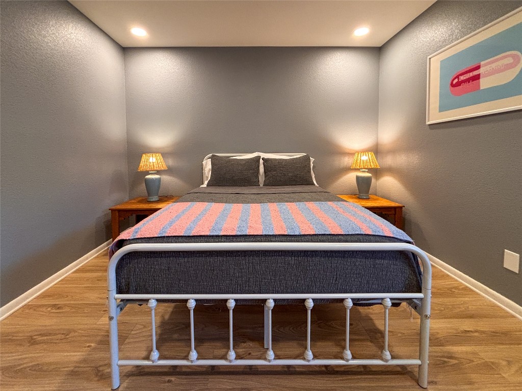 406 Concho Street, Unit B Lockhart, TX 78644 - Photo 11 of 21 a bed room with a bed and lamp