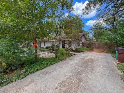 a view of a house with a yard and tree s