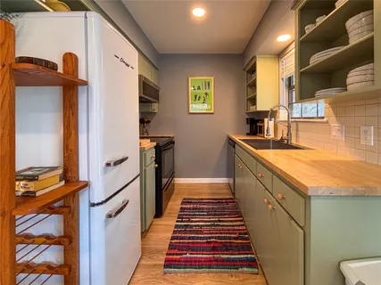 a kitchen with sink cabinets and wooden floor