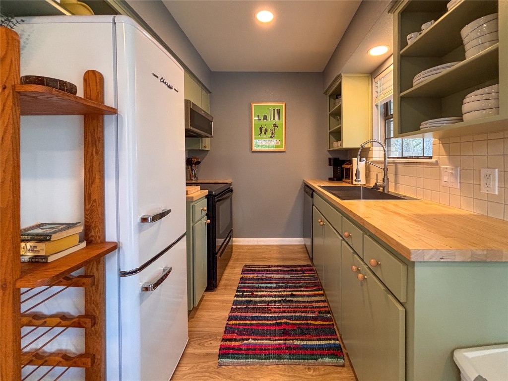 406 Concho Street, Unit B Lockhart, TX 78644 - Photo 9 of 21 a kitchen with sink cabinets and wooden floor