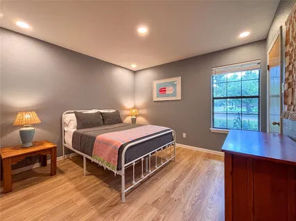 a bedroom with bed and a window