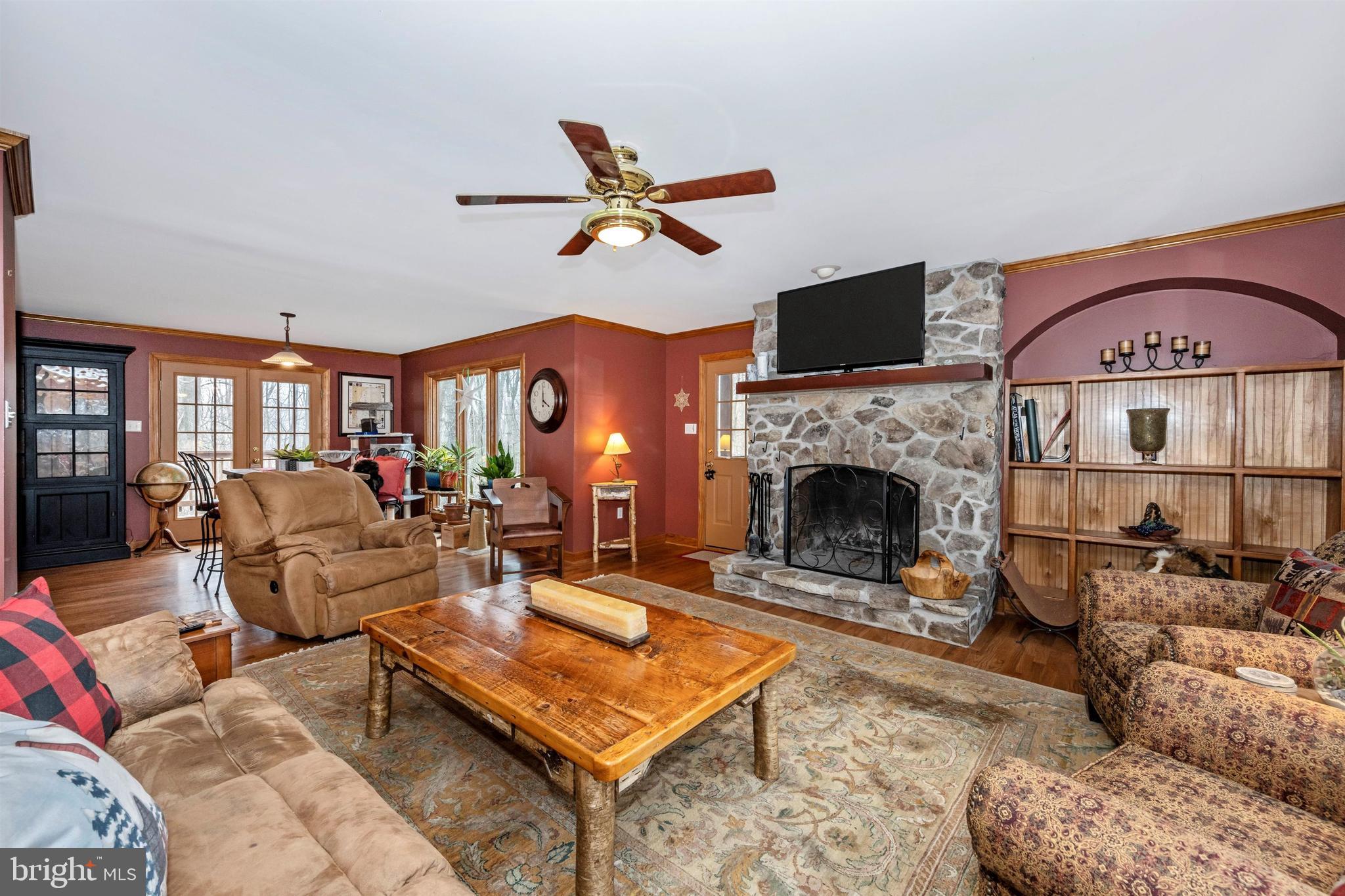 5130 Shookstown Road Frederick, MD 21702 - Photo 14 of 87 a living room with furniture a flat screen tv and a fireplace