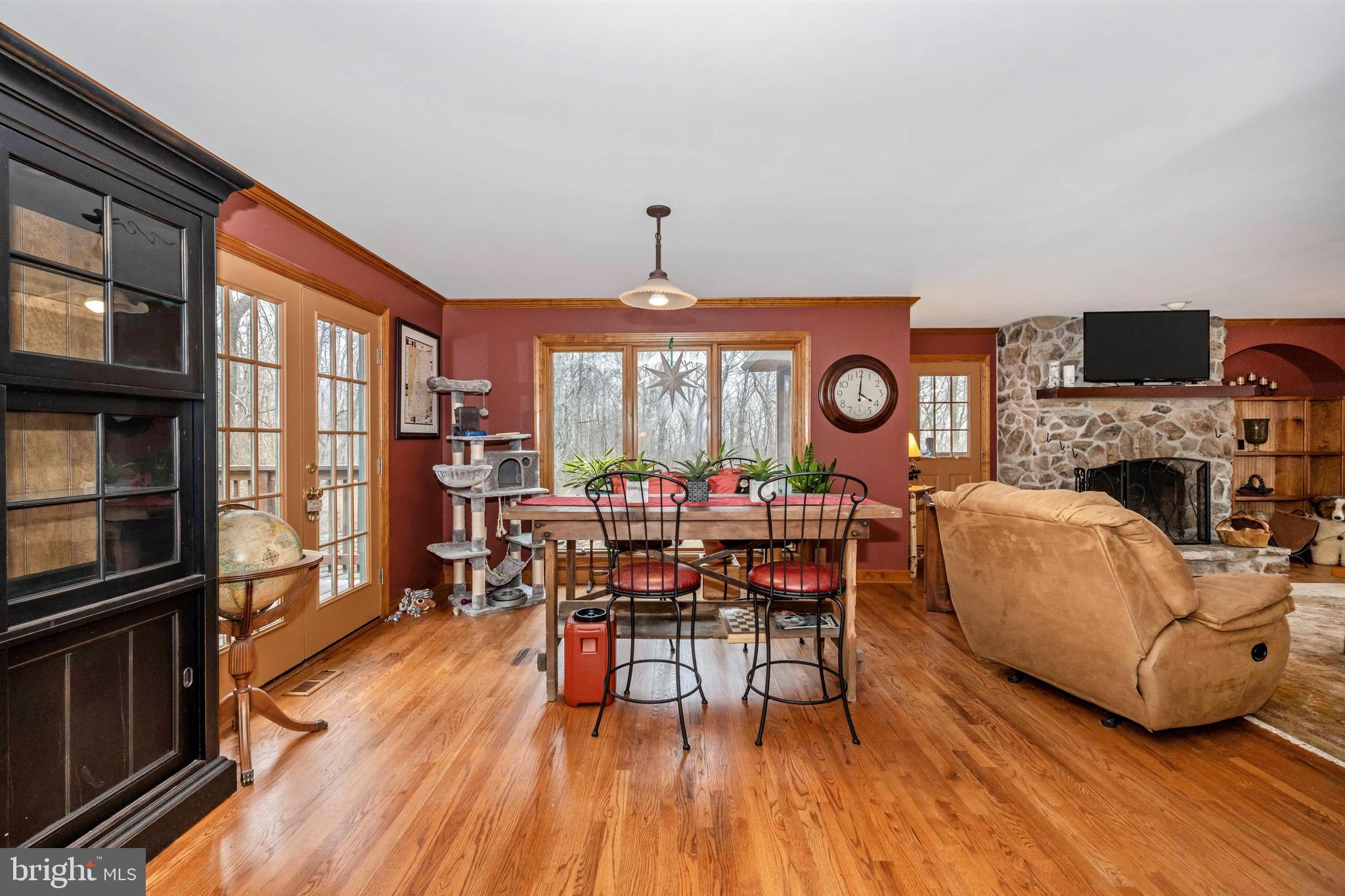 5130 Shookstown Road Frederick, MD 21702 - Photo 15 of 87 a living room with furniture a fireplace and a dining table with wooden floor