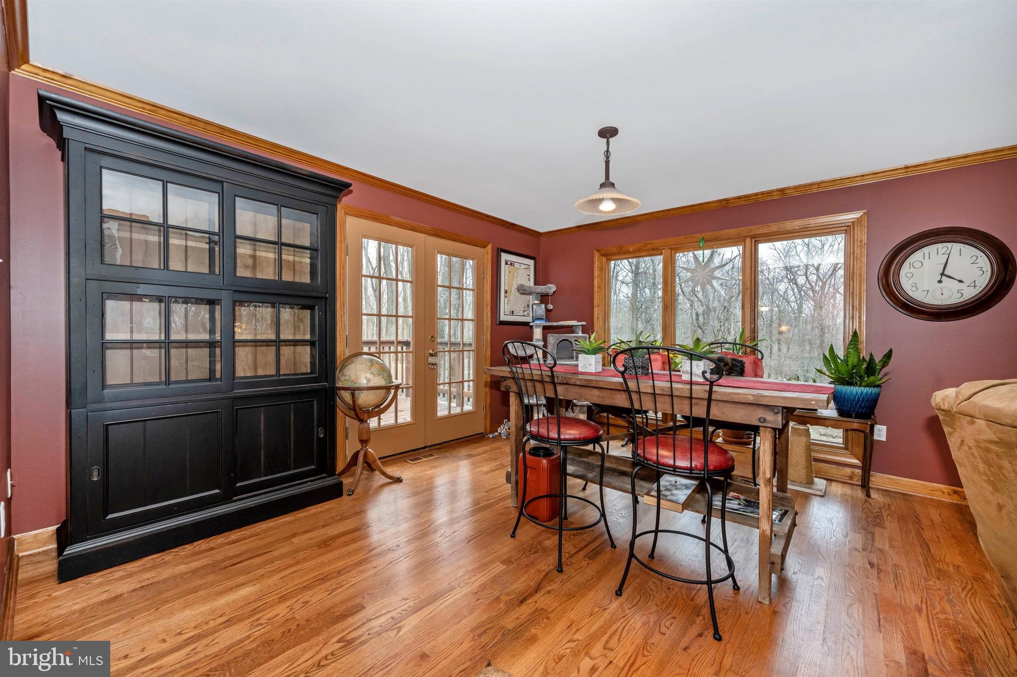 5130 Shookstown Road Frederick, MD 21702 - Photo 16 of 87 a view of a dining room with furniture window and wooden floor