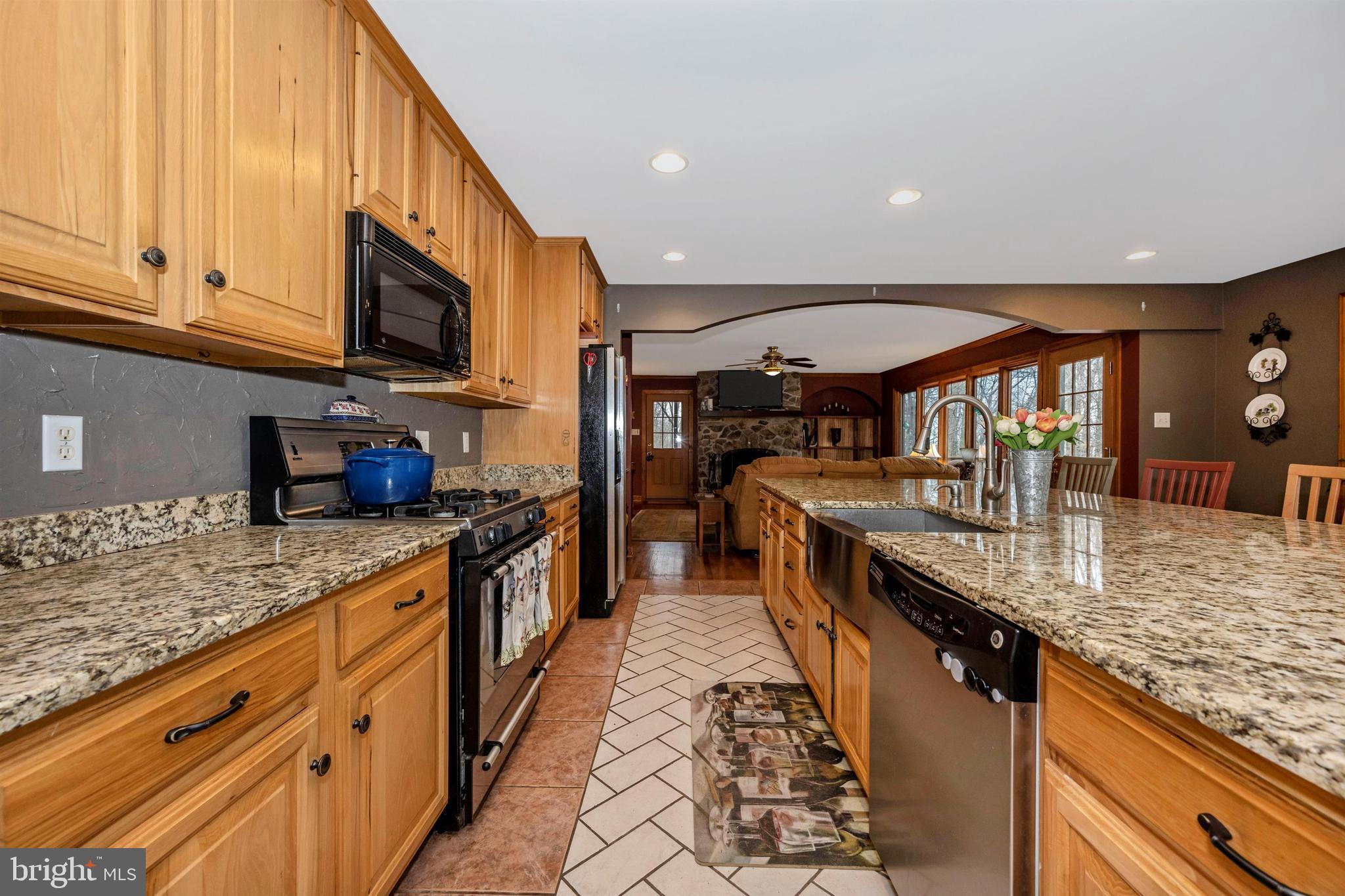 5130 Shookstown Road Frederick, MD 21702 - Photo 19 of 87 a large kitchen with stainless steel appliances granite countertop a large counter top a stove and a sink