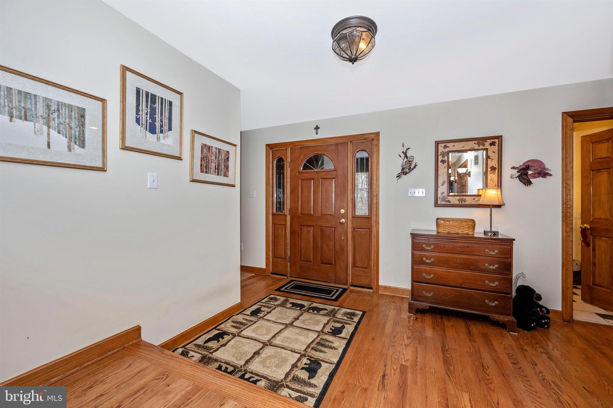 5130 Shookstown Road Frederick, MD 21702 - Photo 40 of 87 a bedroom with a bed and a chandelier