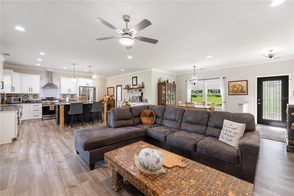 5149 Southwest 119th Road Lake Butler, FL 32054 - Photo 6 of 40 a living room with furniture kitchen view and a wooden floor