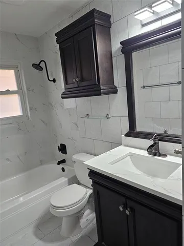 a bathroom with a sink a toilet and bathtub
