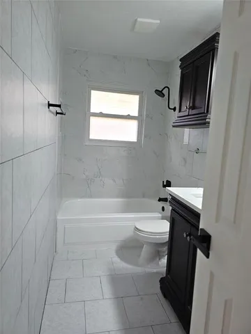 a bathroom with a toilet a sink and bathtub