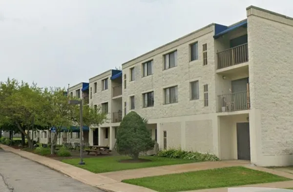a front view of a building with garden