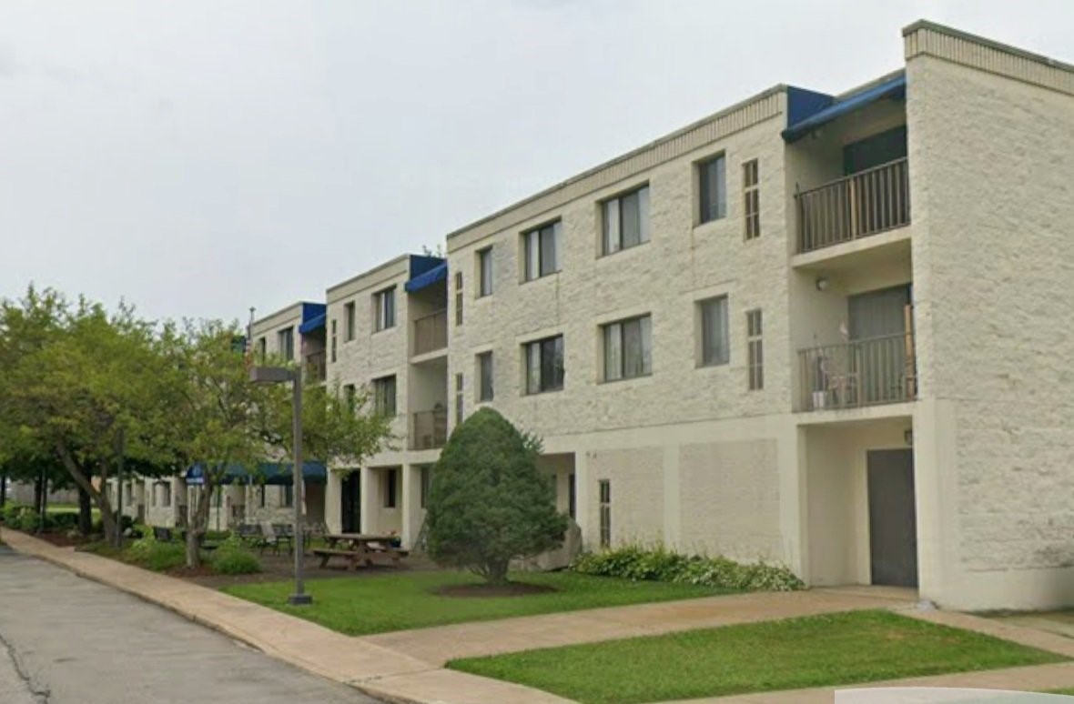 a front view of a building with garden