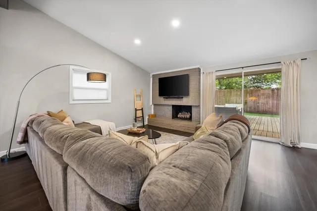 a living room with furniture fireplace and a flat screen tv