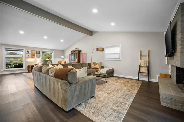 a living room with furniture a rug and a flat screen tv