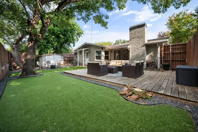 a front view of a house with a garden and patio