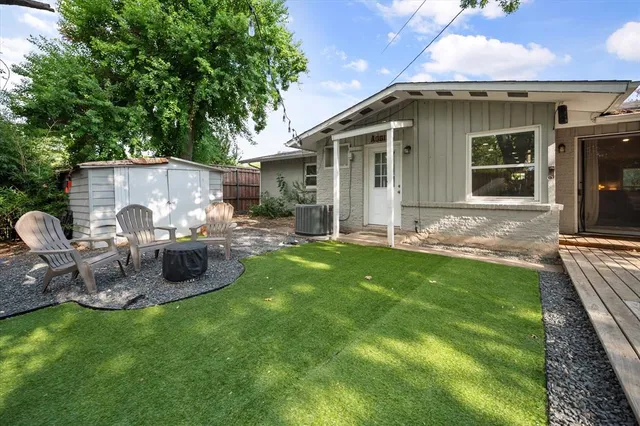 a backyard of a house with table and chairs