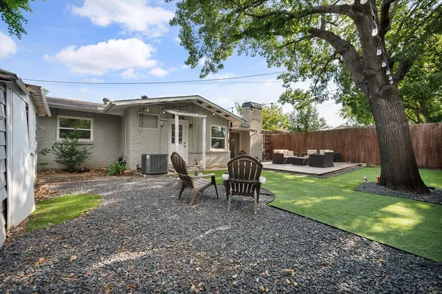 a view of a house with backyard sitting area and garden