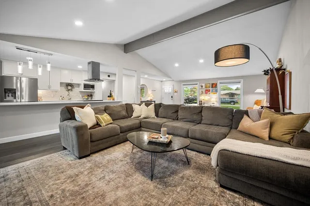 a living room with furniture and a lamp