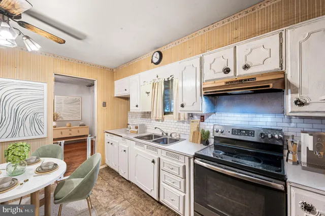 a kitchen with stainless steel appliances granite countertop a stove and a microwave