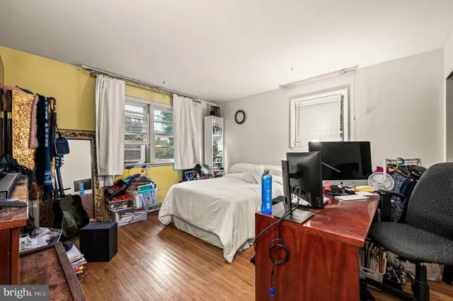 a bedroom with furniture and a flat screen tv