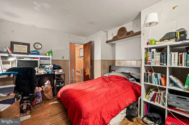 a bed room with a bed and a book shelf