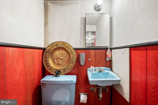 a view of a hallway with furniture and a window