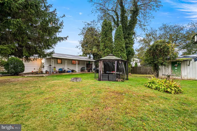 a swimming pool view with a seating space and a garden