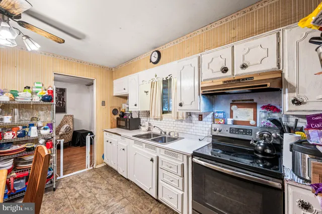 a kitchen with stainless steel appliances granite countertop a stove and cabinets
