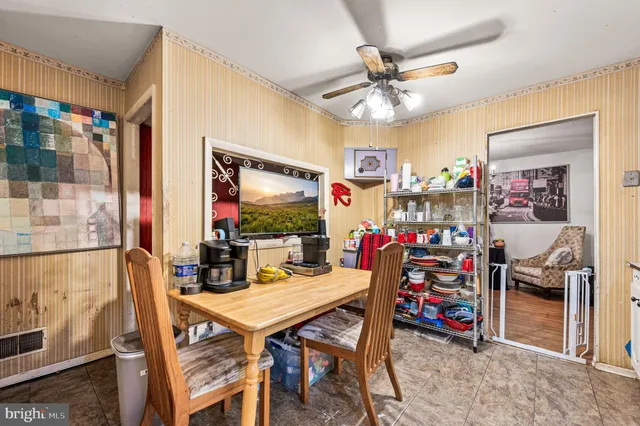 a view of a dining room with furniture and a chandelier
