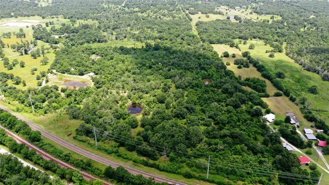 a view of a lake in middle of green field
