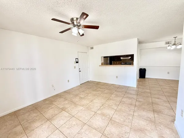 a view of a livingroom with a ceiling fan and window