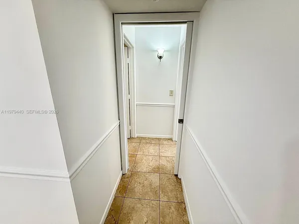 a view of a room with wooden floor and fan