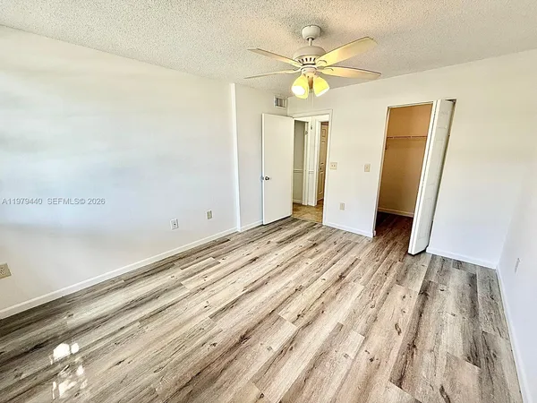 a view of walk in closet with empty racks