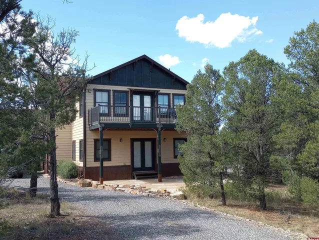 a view of a livingroom with furniture wooden floor and windows