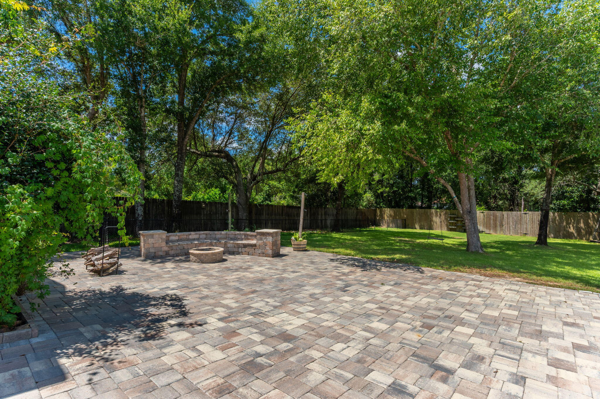 14 Blenheim Road Shalimar, FL 32579 - Photo 62 of 71 a view of a backyard with table and chairs a barbeque and a large trees