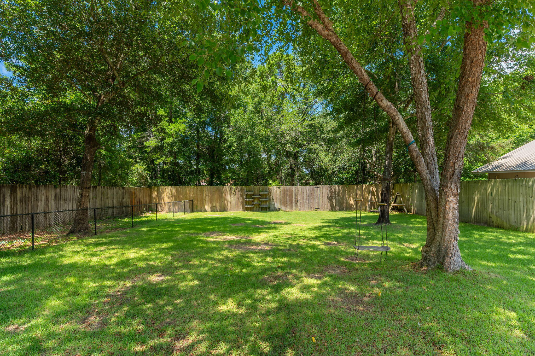14 Blenheim Road Shalimar, FL 32579 - Photo 64 of 71 a backyard of a house with lots of plants and large tree